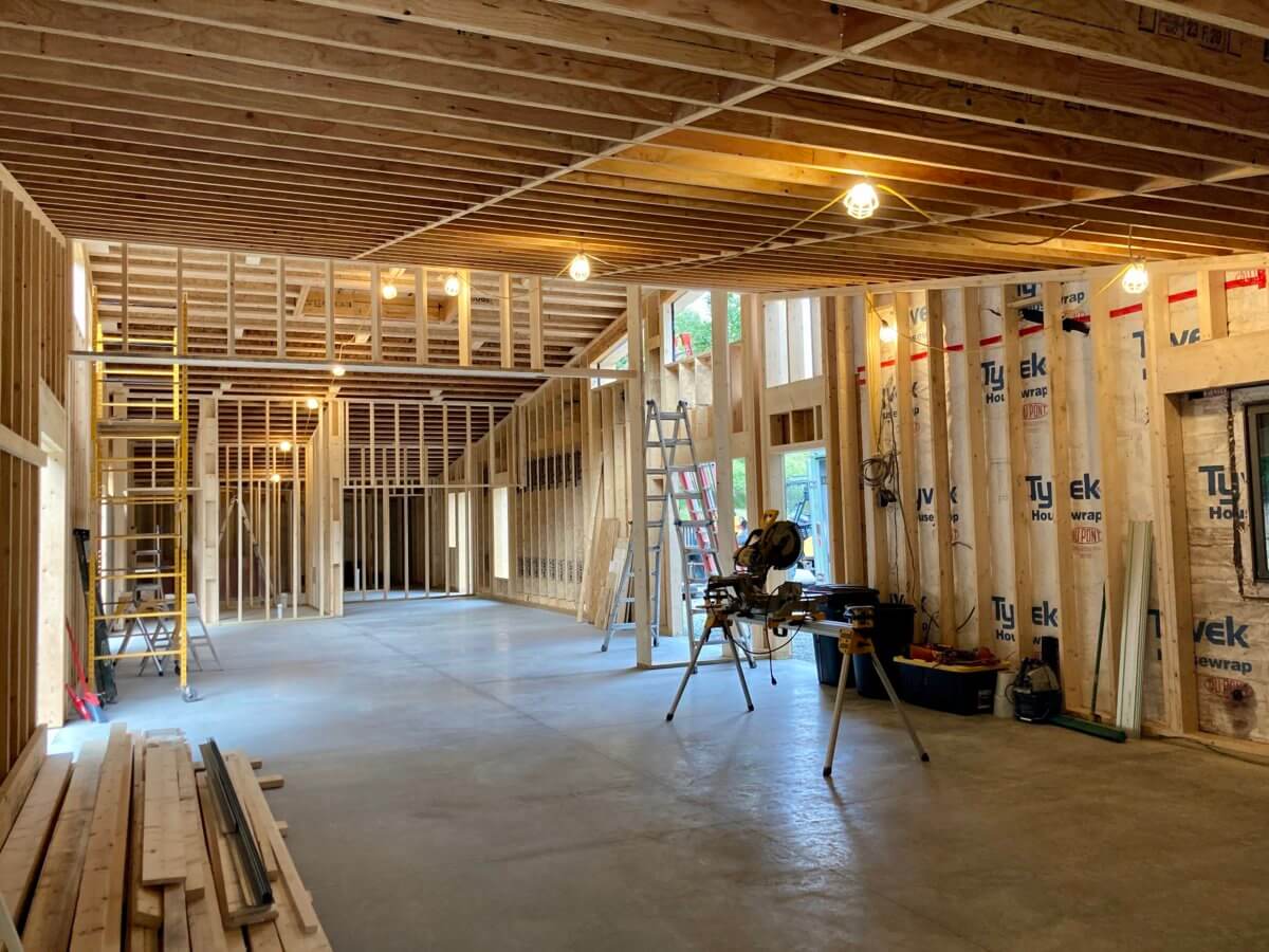 interior of the new addition with cement floor and all interior framing complete