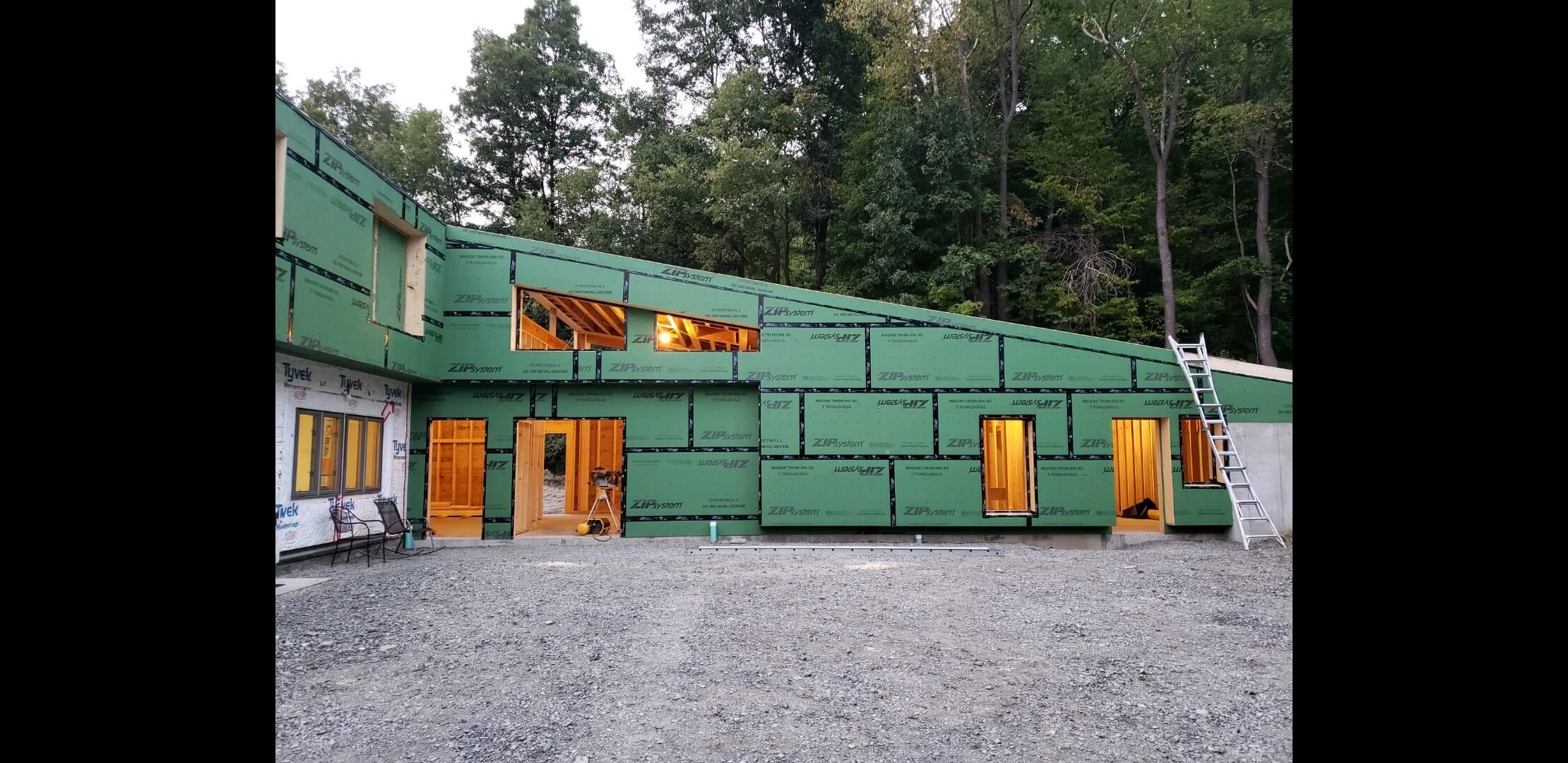 fully framed addition lit from within with through door and window openings