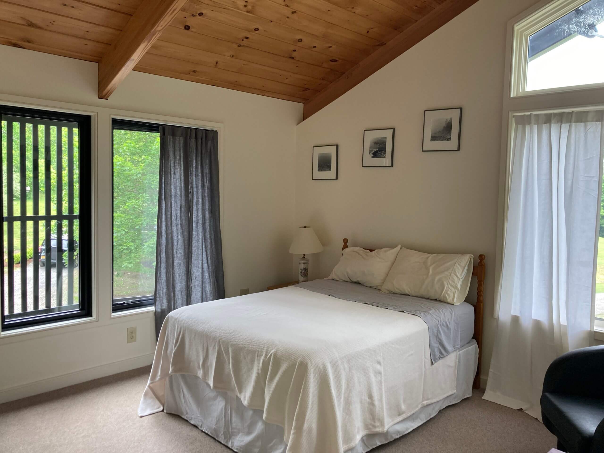 visual arts studio with vaulted ceiling, large windows, and a vinyl tile floor
