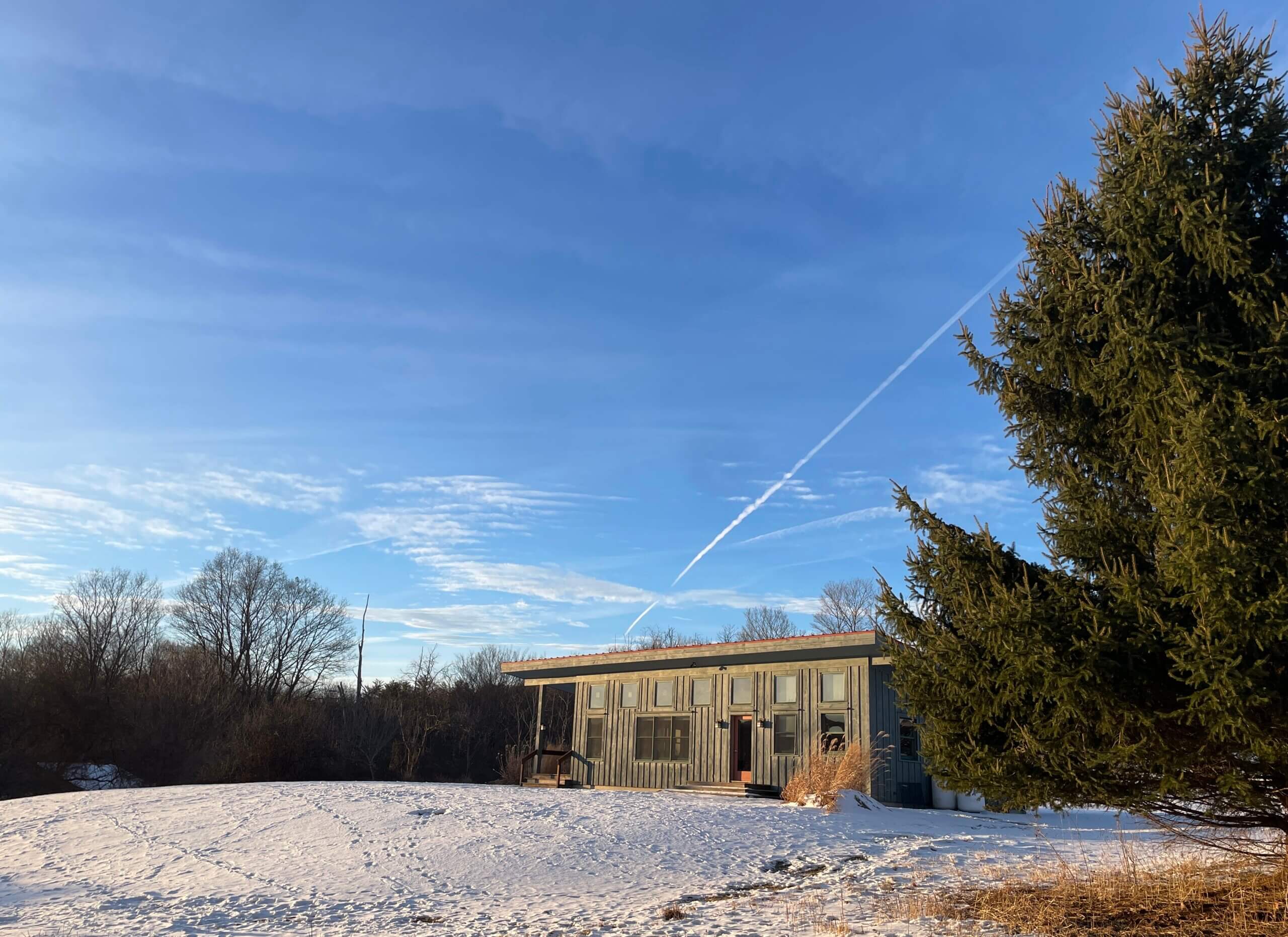 Saltonstall's single-story office in mid-February with snow on the lawn and a brilliant blue sky.