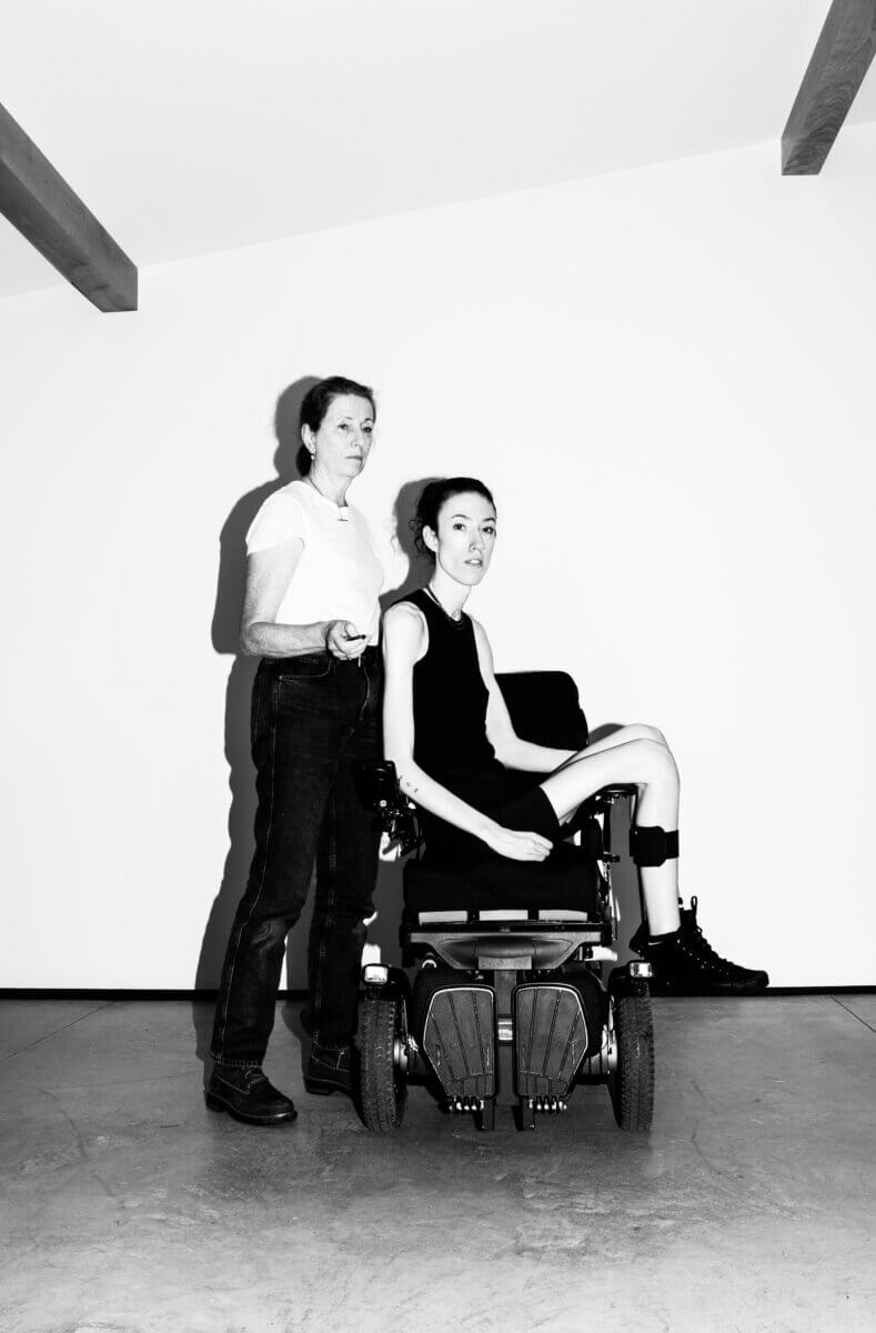 self portrait of photographer Natalie de Segonzac seated in a wheelchair with her mother and Jane Bohan standing next to her in the Saltonstall studio